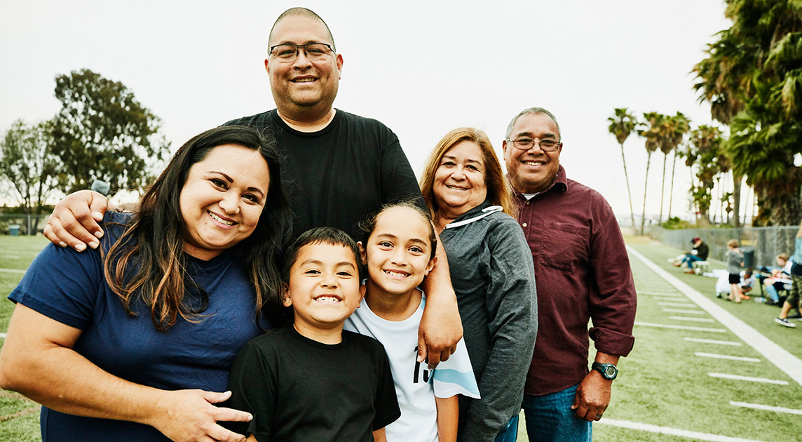 A multi-generational family of Covered California members smiles in their front yard.